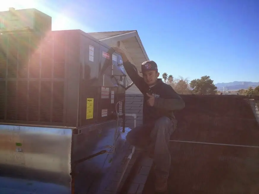 HVAC technician performing HVAC Inspection on a rooftop unit in Dunellen